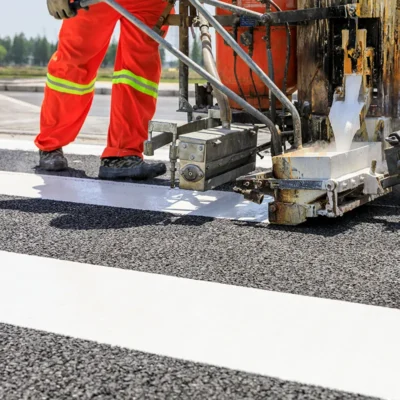 Working painting stripes on a road
